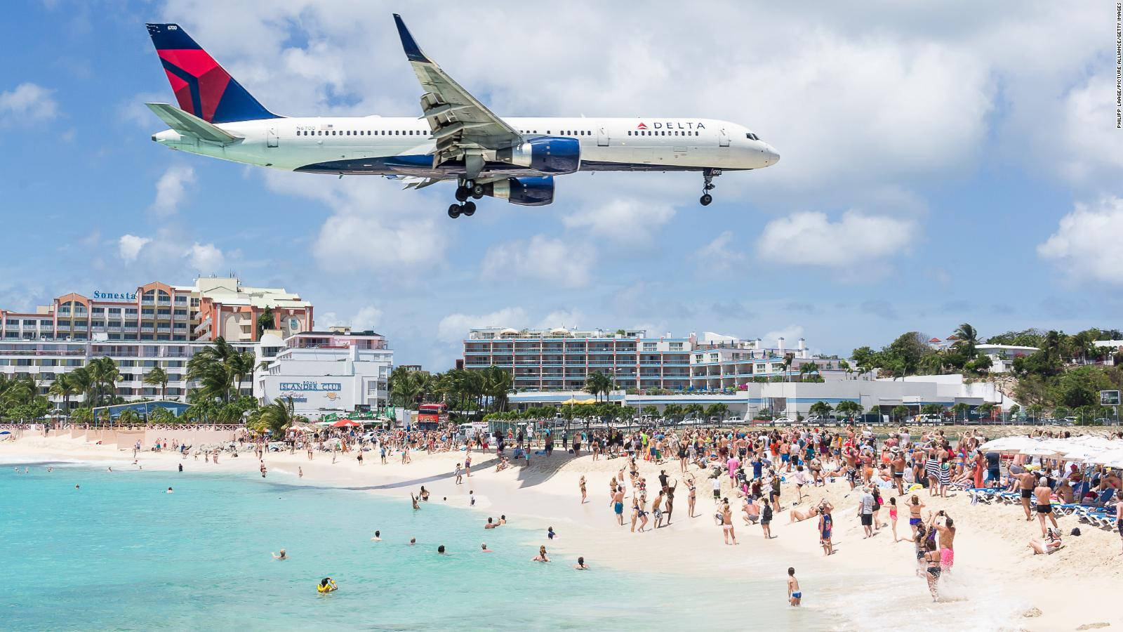 Delta Airlines Flying Over A Beach In Sint Maarten Wallpaper