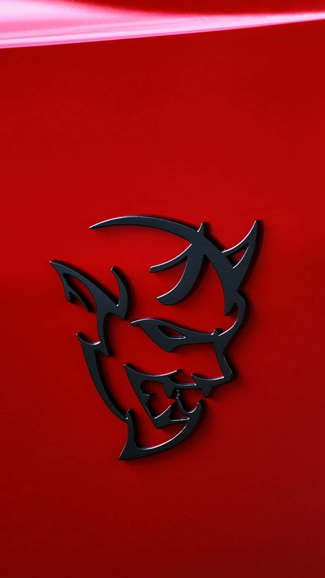 A Red Car With A Devil Hood Emblem Wallpaper