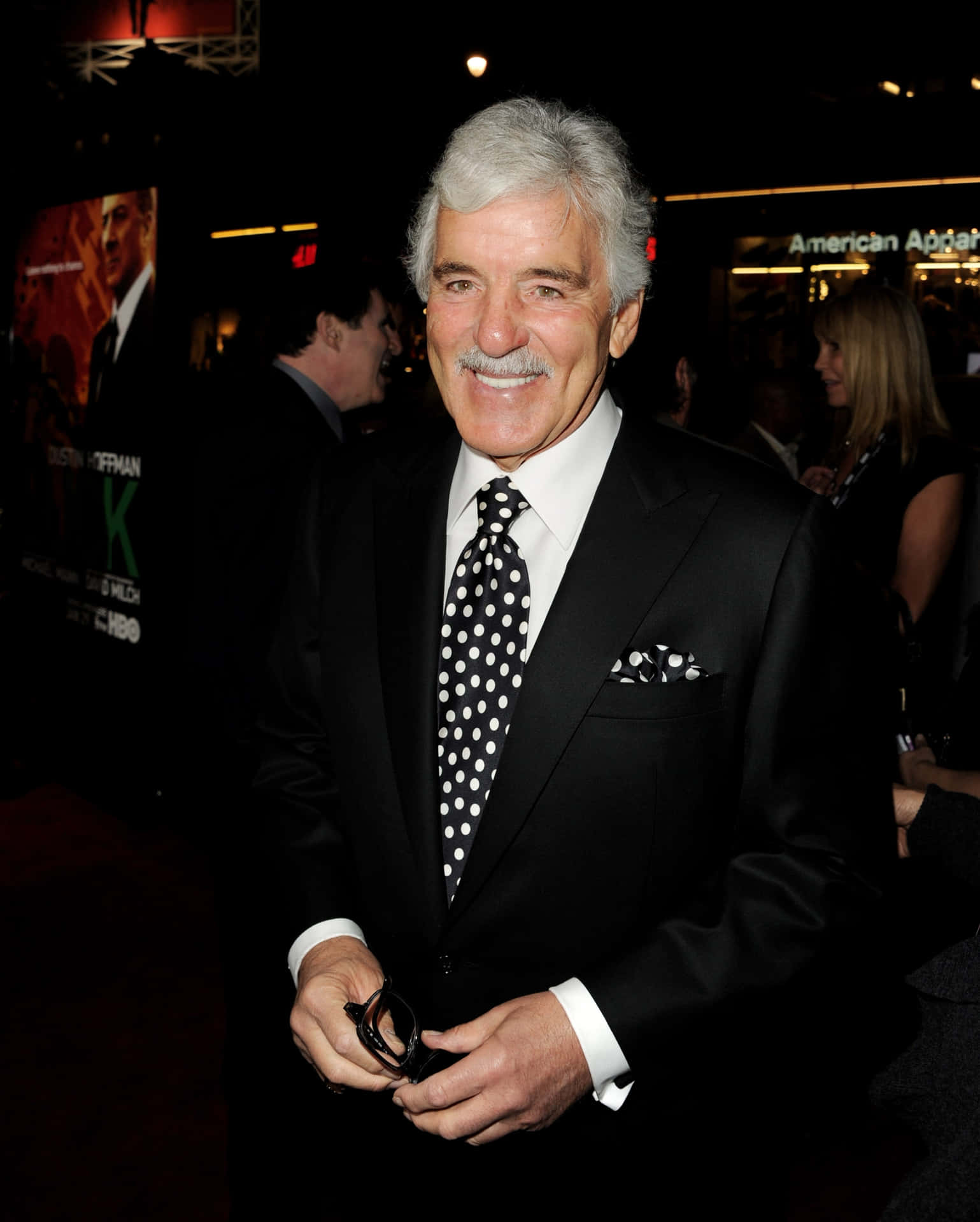 Dennis Farina, the esteemed actor, standing in a sharp-looking suit Wallpaper