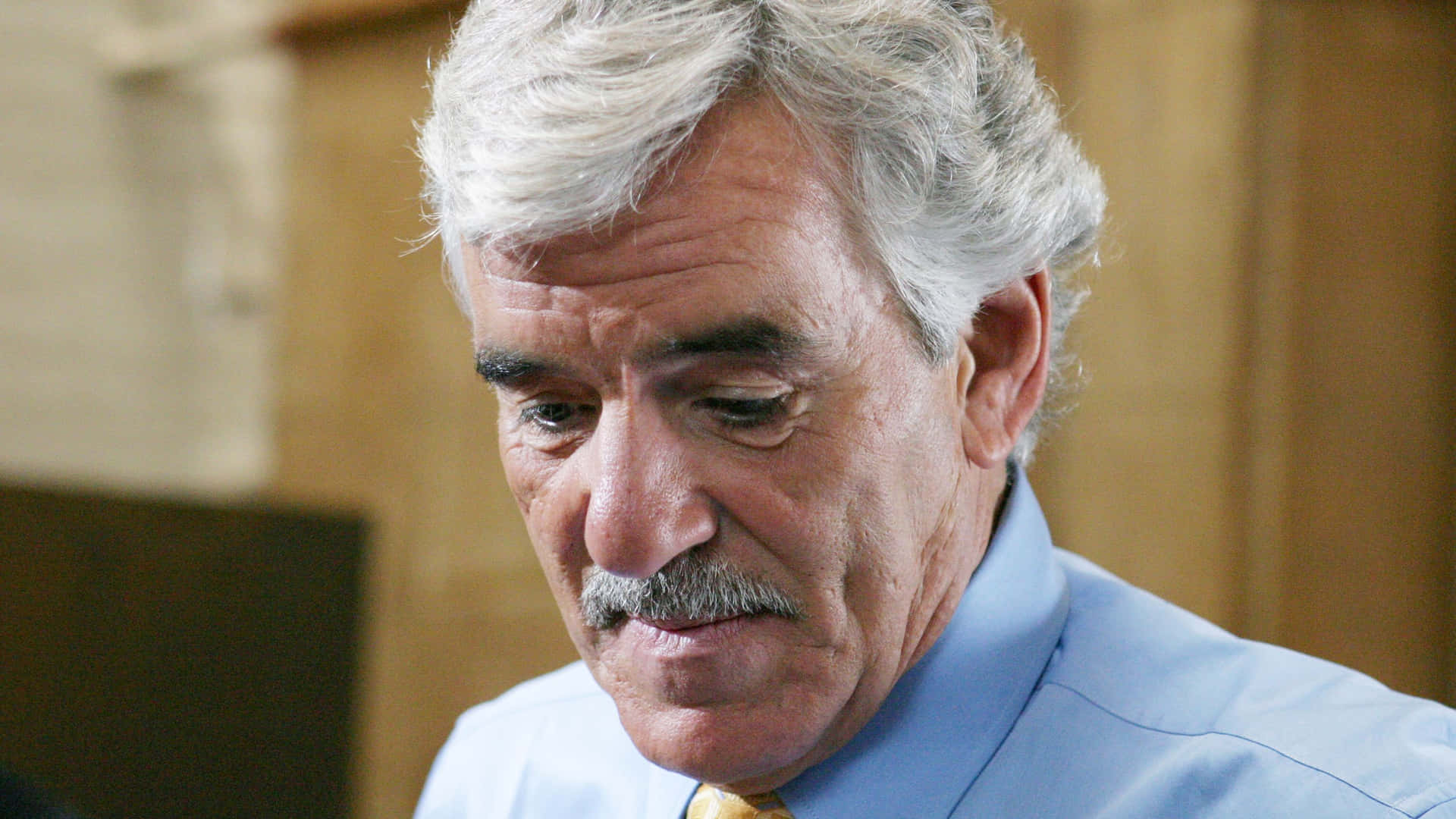 Dennis Farina Smiling on a Blue Background Wallpaper