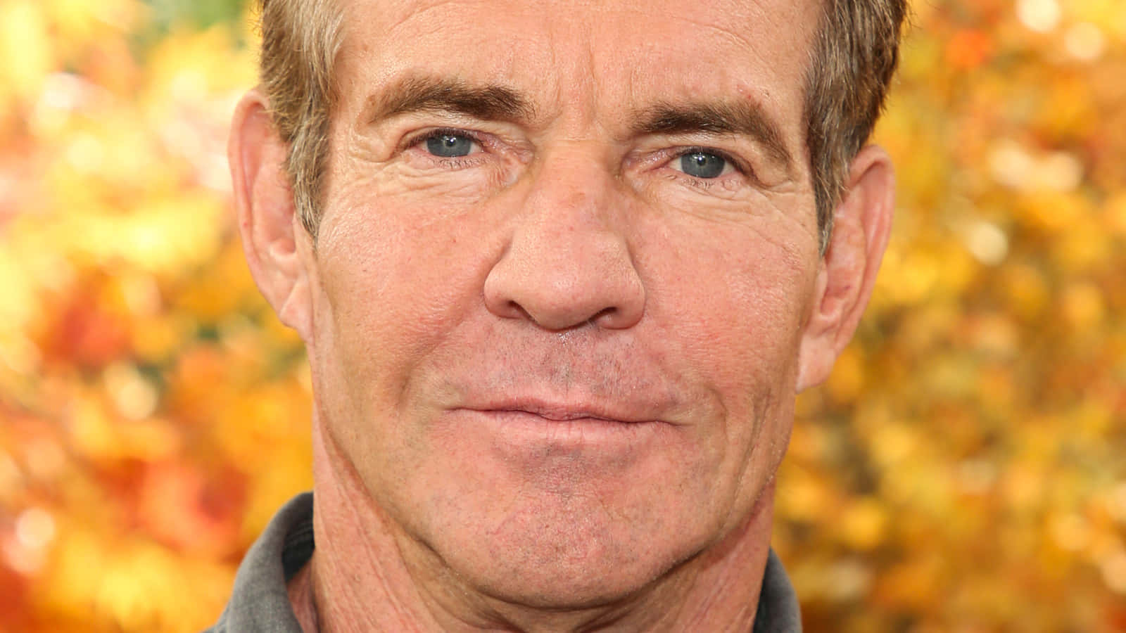 Dennis Quaid showing his iconic smirk Wallpaper