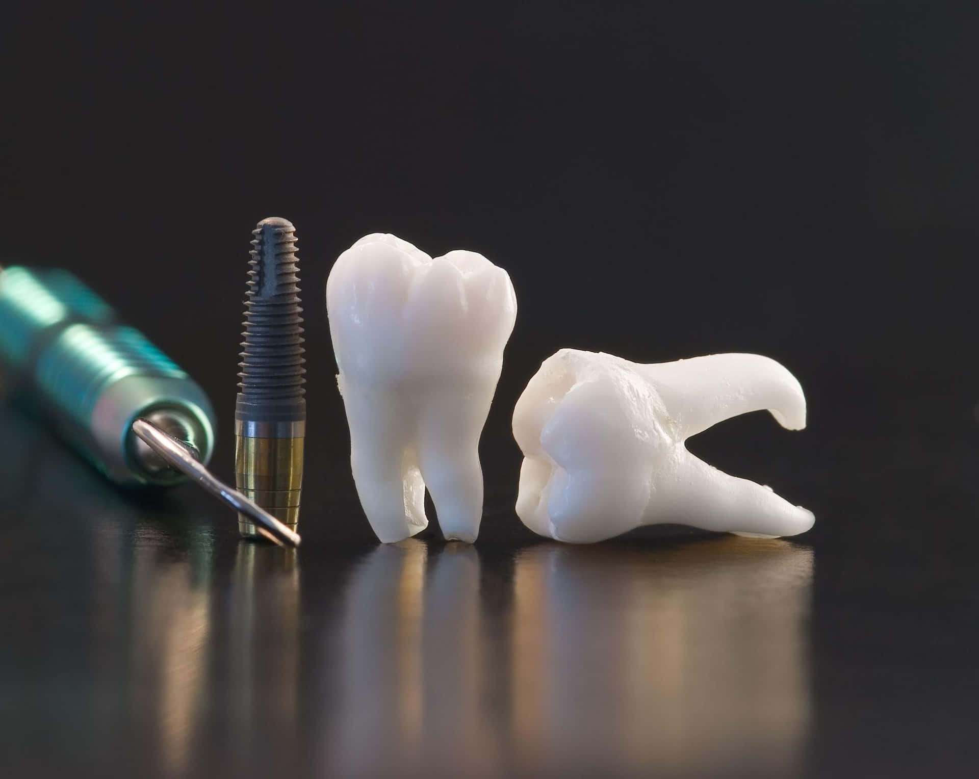 A Tooth And A Dental Implant On A Black Surface