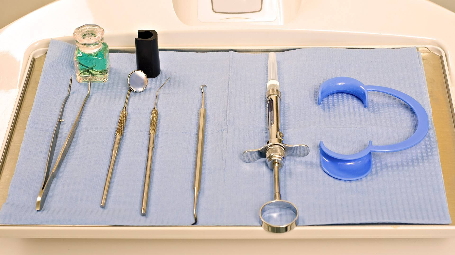 Top View of Various Dental Tools on Dentist's Tray Wallpaper