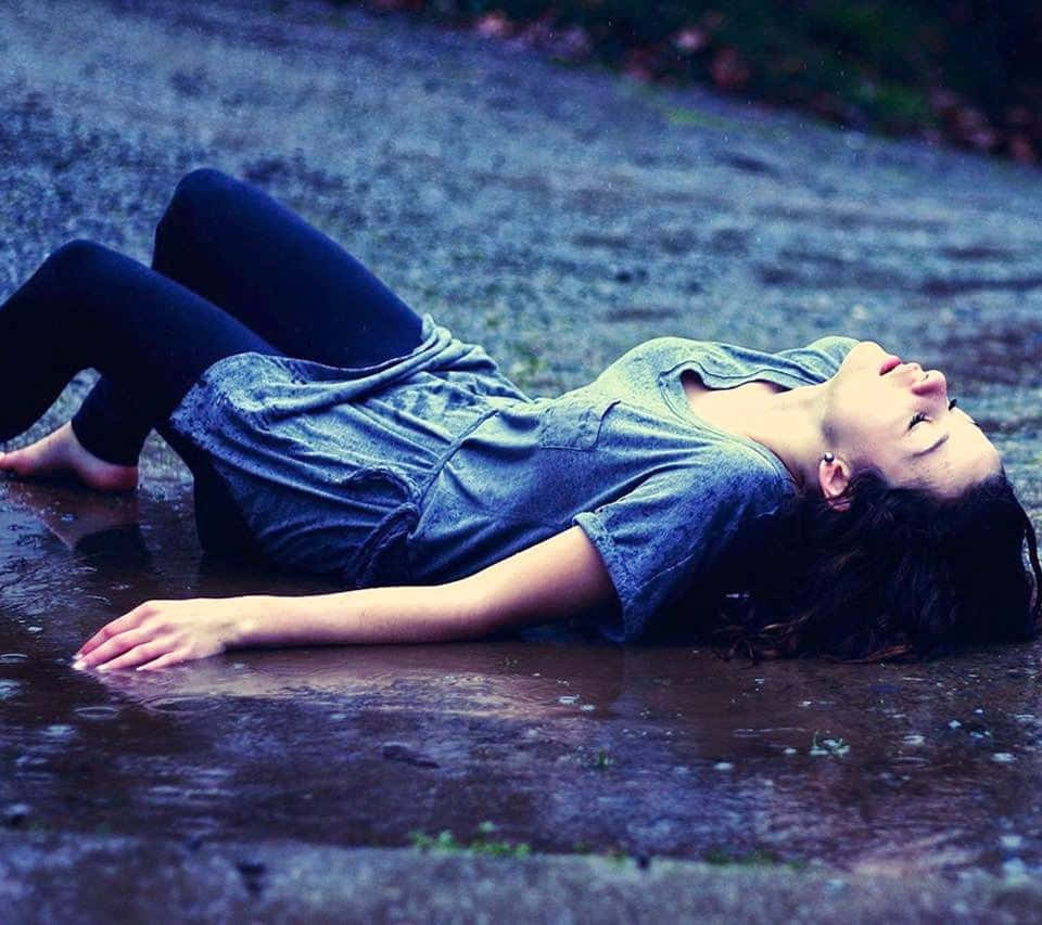 a girl laying in a puddle