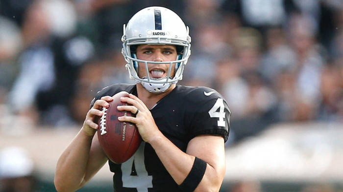 Derek Carr Holding Football With Two Hands Wallpaper