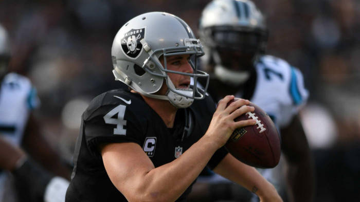 Derek Carr Holds The Football With One Hand Wallpaper