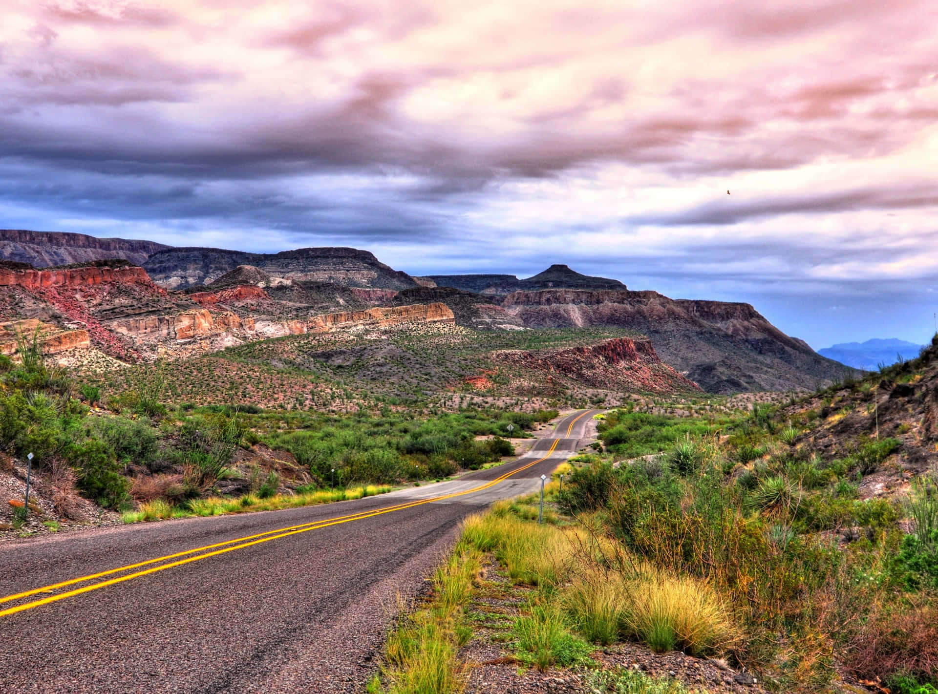 Desert_ Road_ Through_ Mountainous_ Landscape Wallpaper