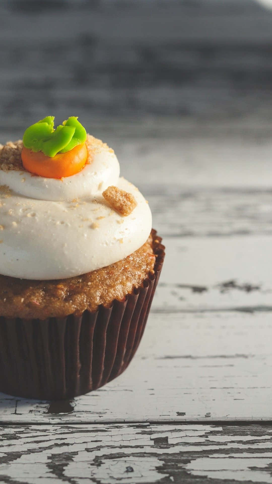 A Cupcake With Carrots On Top Wallpaper