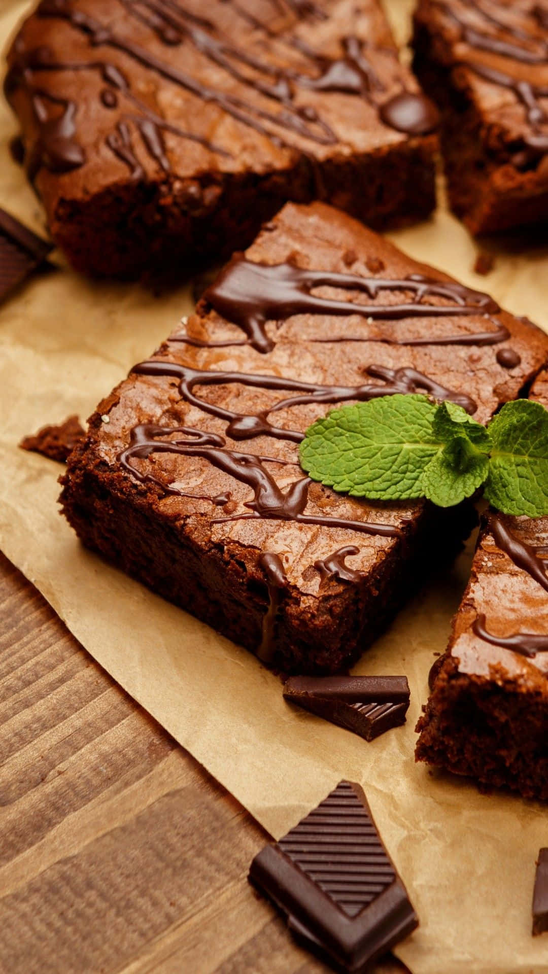 Chocolate Brownies With Mint Leaves On A Brown Paper Wallpaper