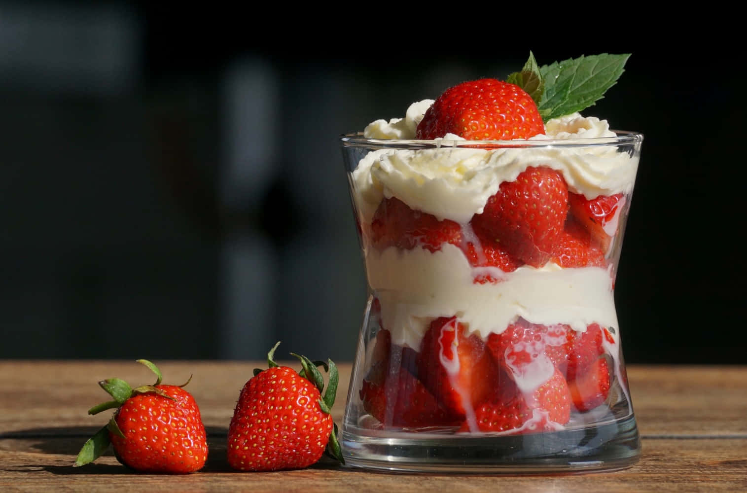 A Glass Of Strawberry Trifle With Whipped Cream And Strawberries