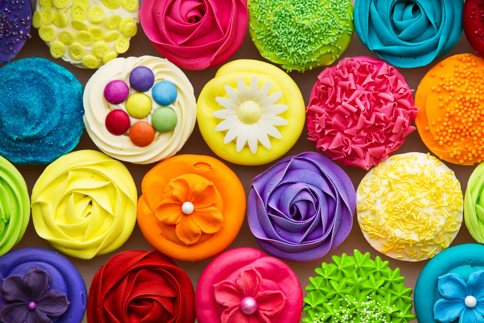 A Colorful Arrangement Of Cupcakes With Flowers