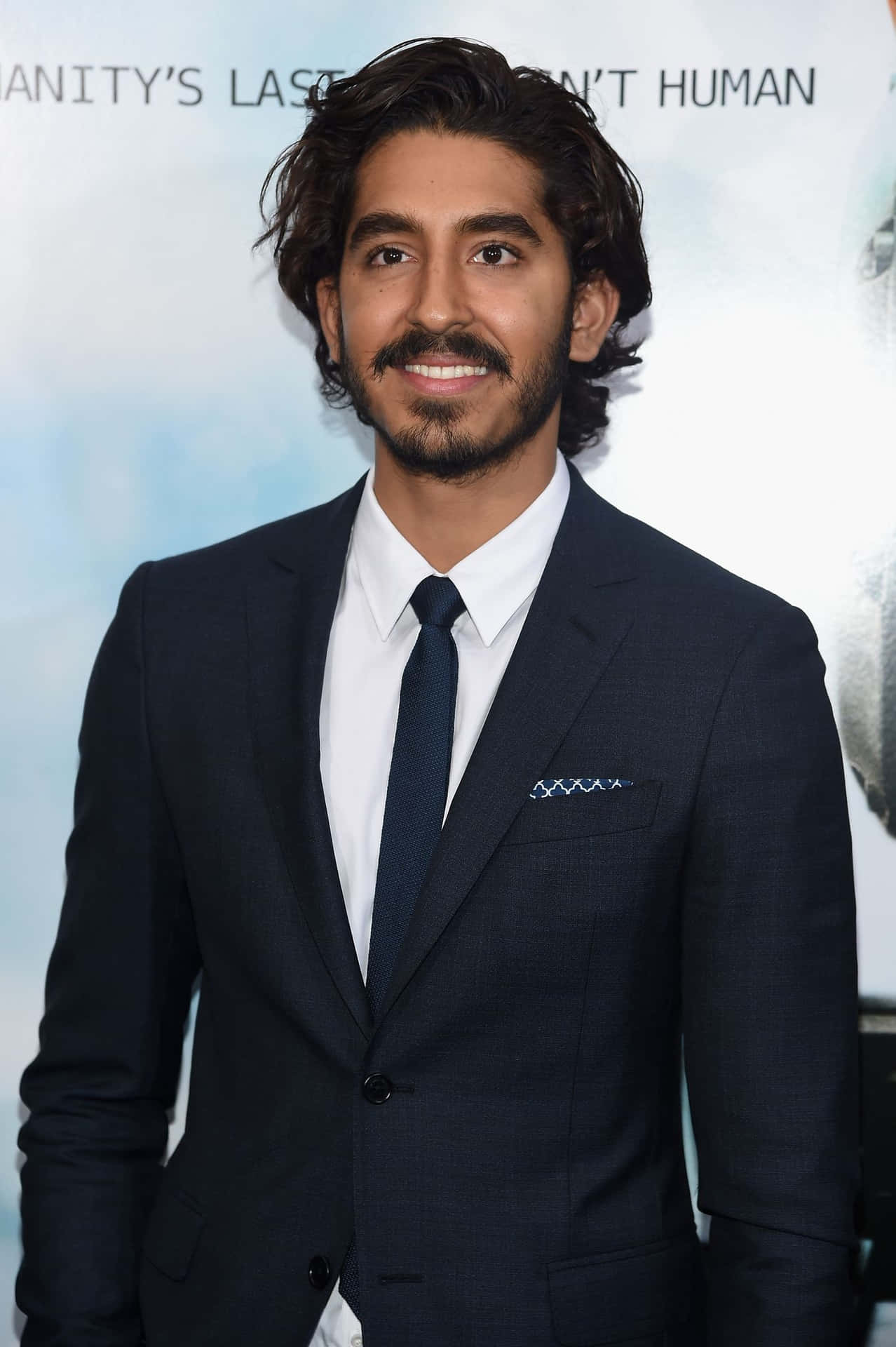 Dev Patel Casual Pose At A Photoshoot Wallpaper