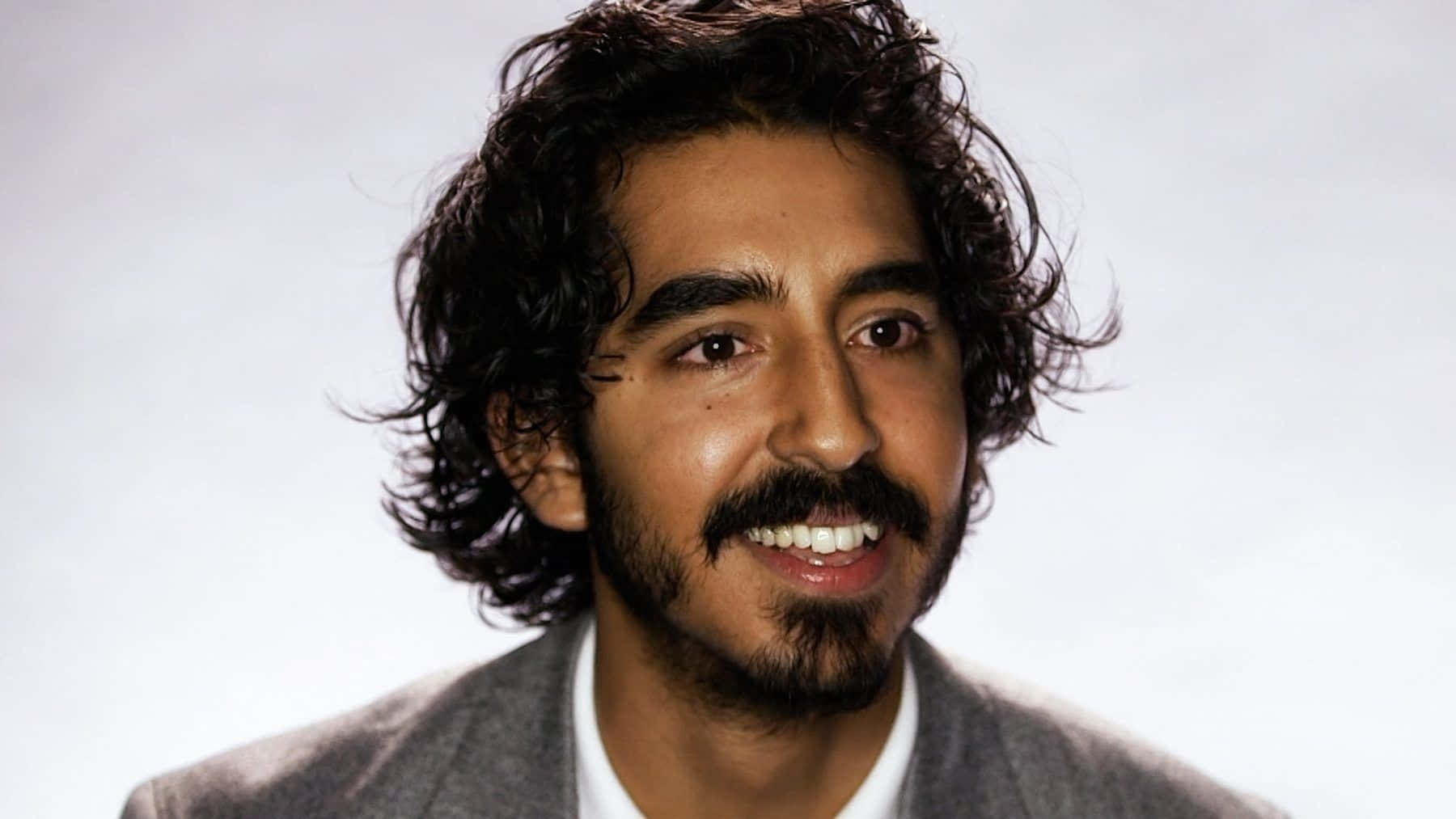 Dev Patel In A Thoughtful Pose. Wallpaper