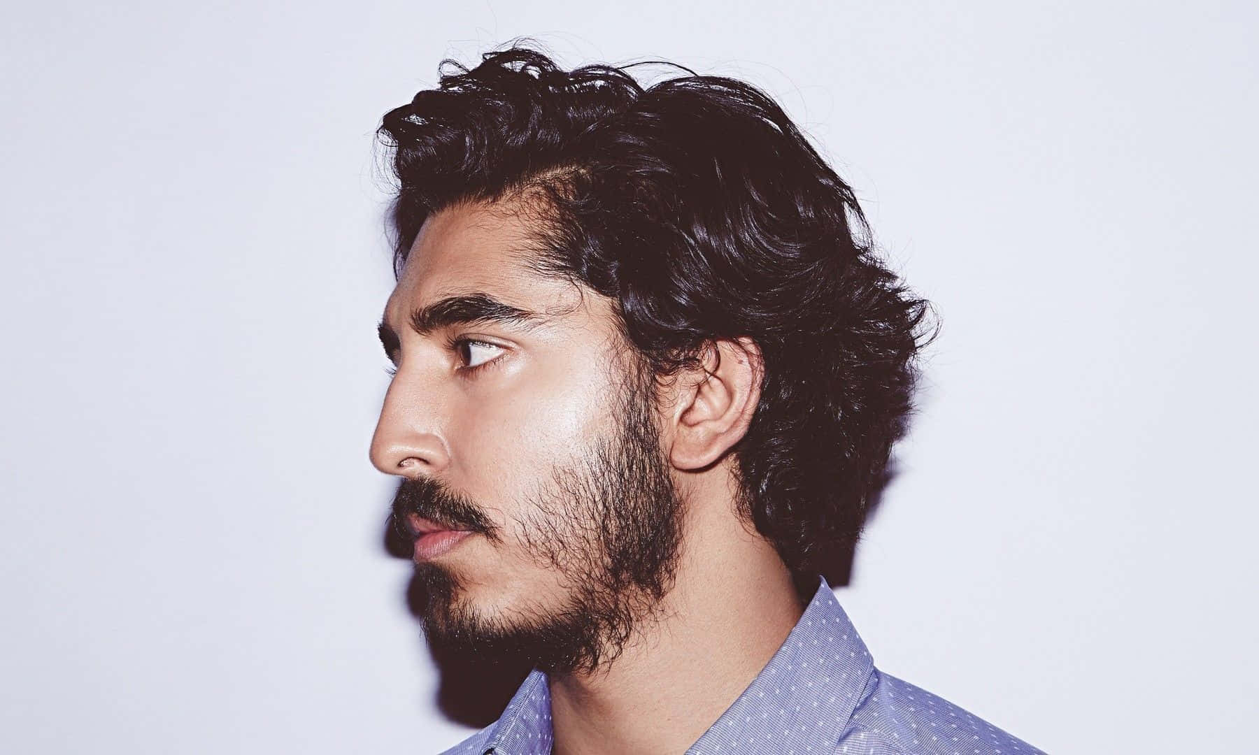 Dev Patel, The Award-winning Actor, Showing His Charisma In A Casual Pose Wallpaper