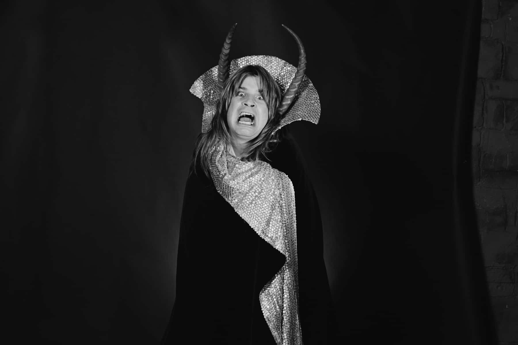 A Woman In A Black And White Photo With Horns