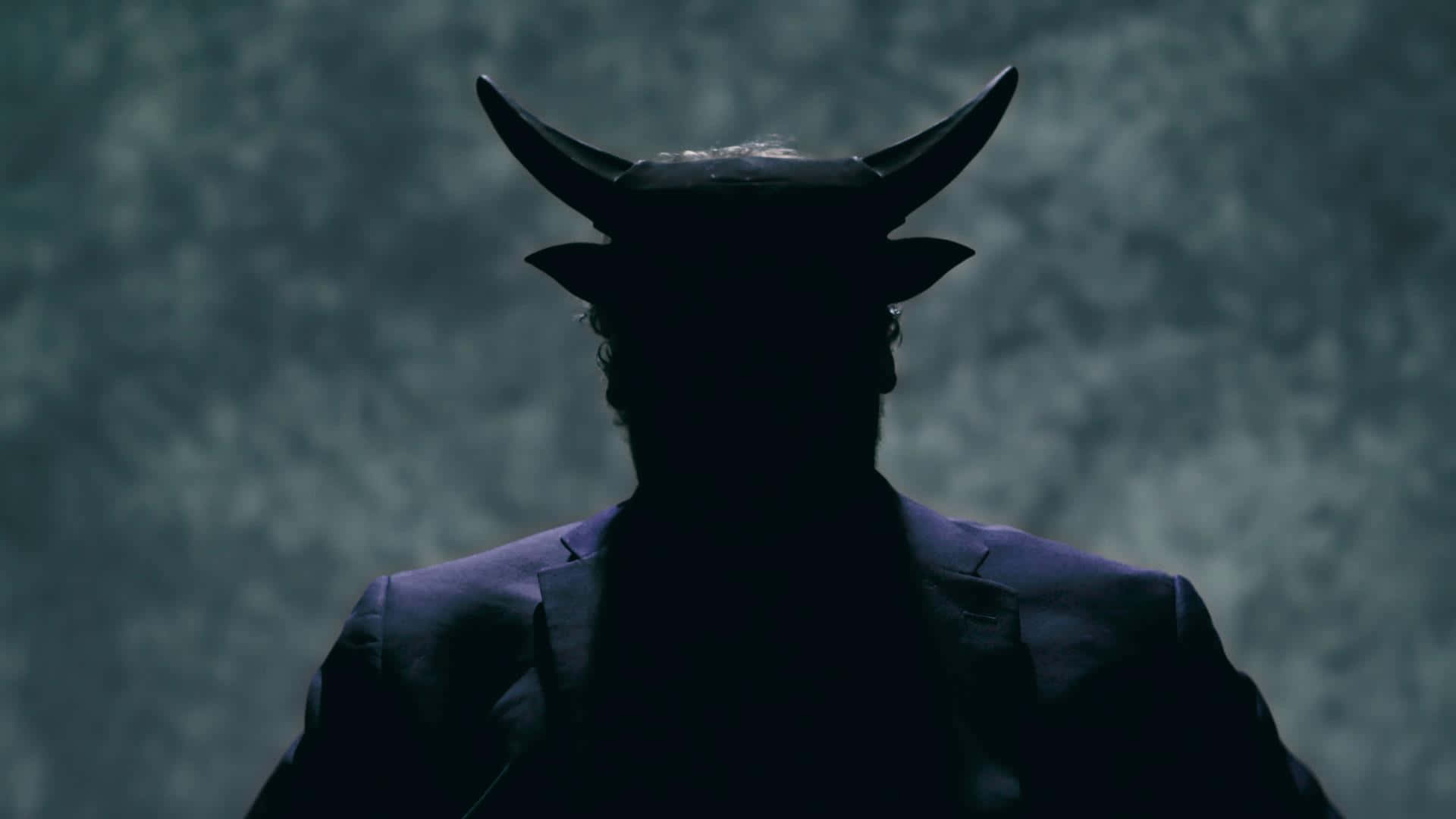 A Man In A Suit With Horns On His Head