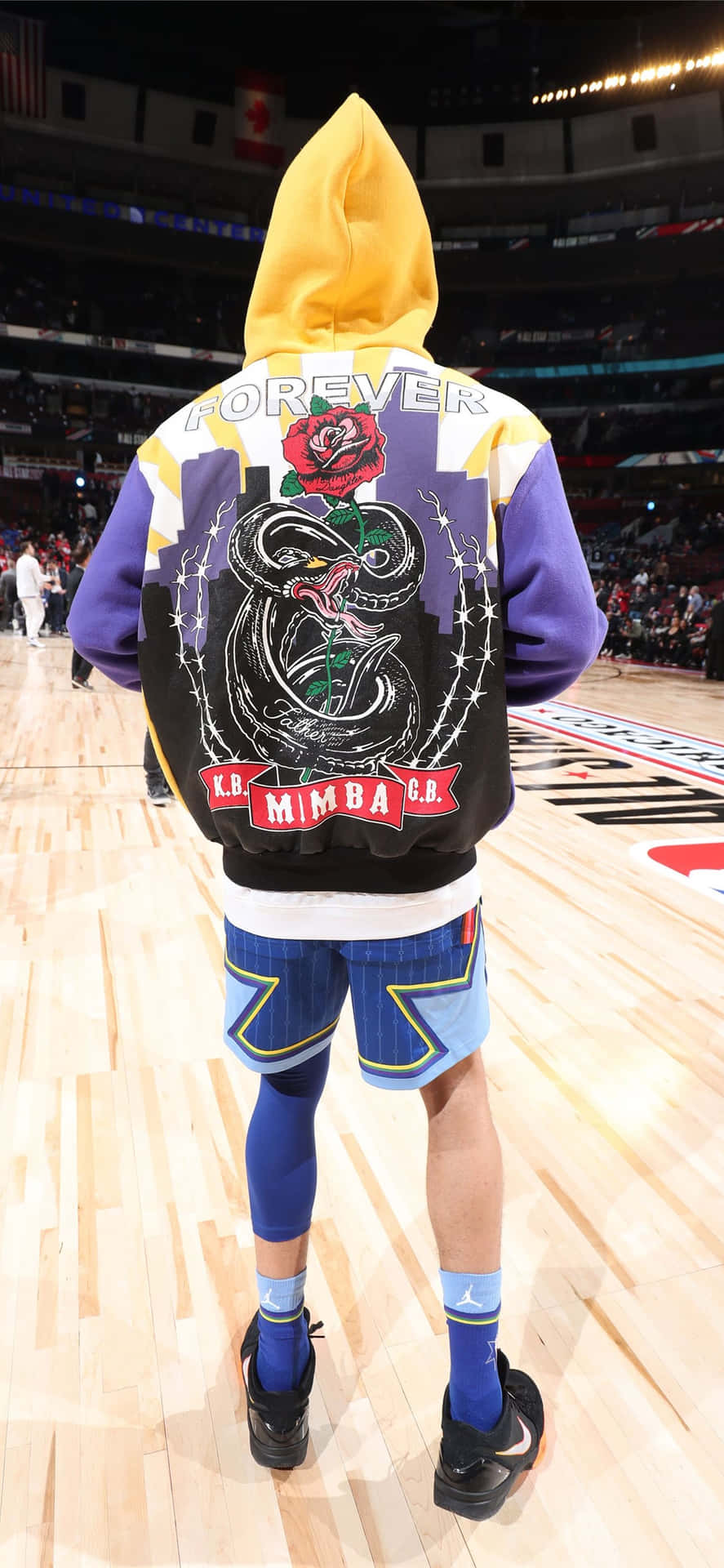 A Basketball Player Wearing A Jacket And Shorts Wallpaper