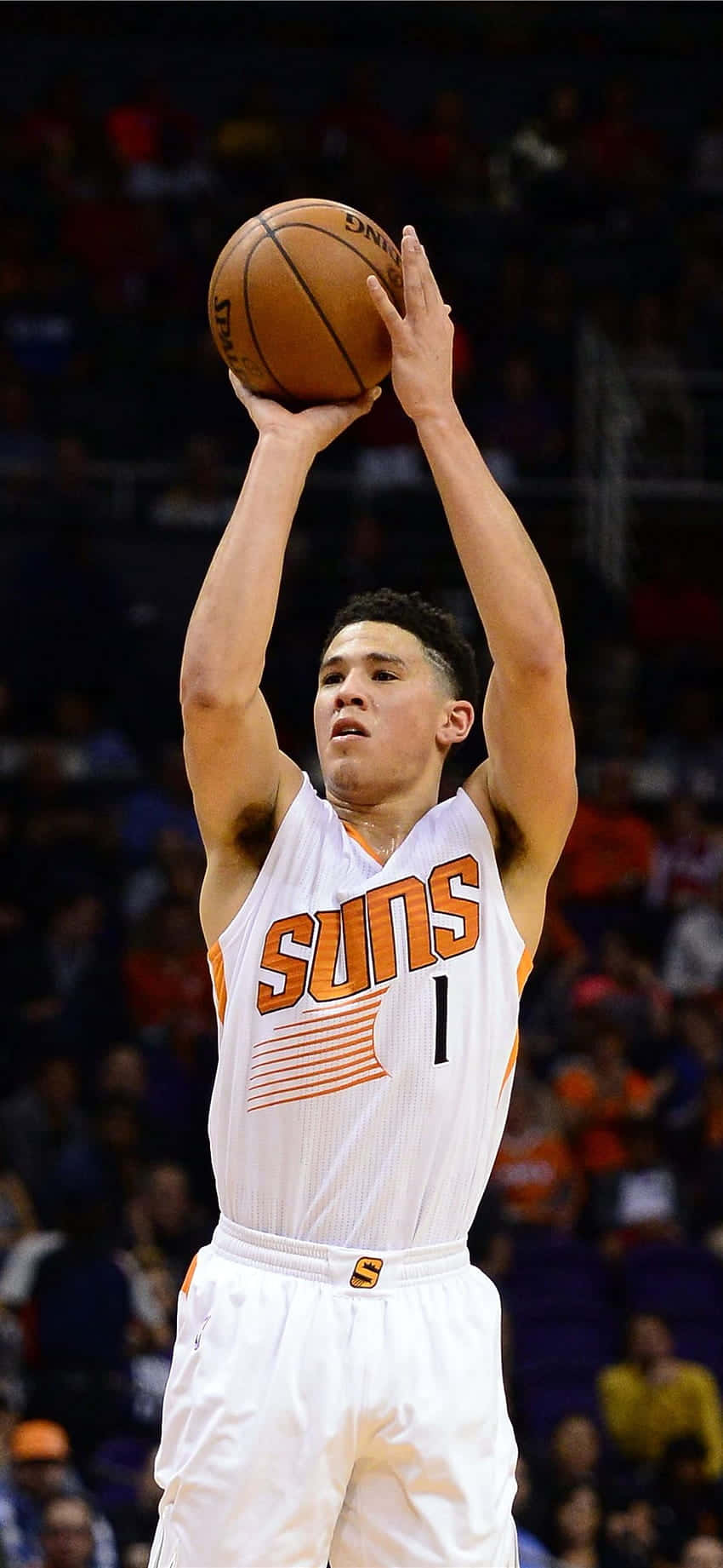 Devin Booker shooting a jump shot with iPhone in hand Wallpaper
