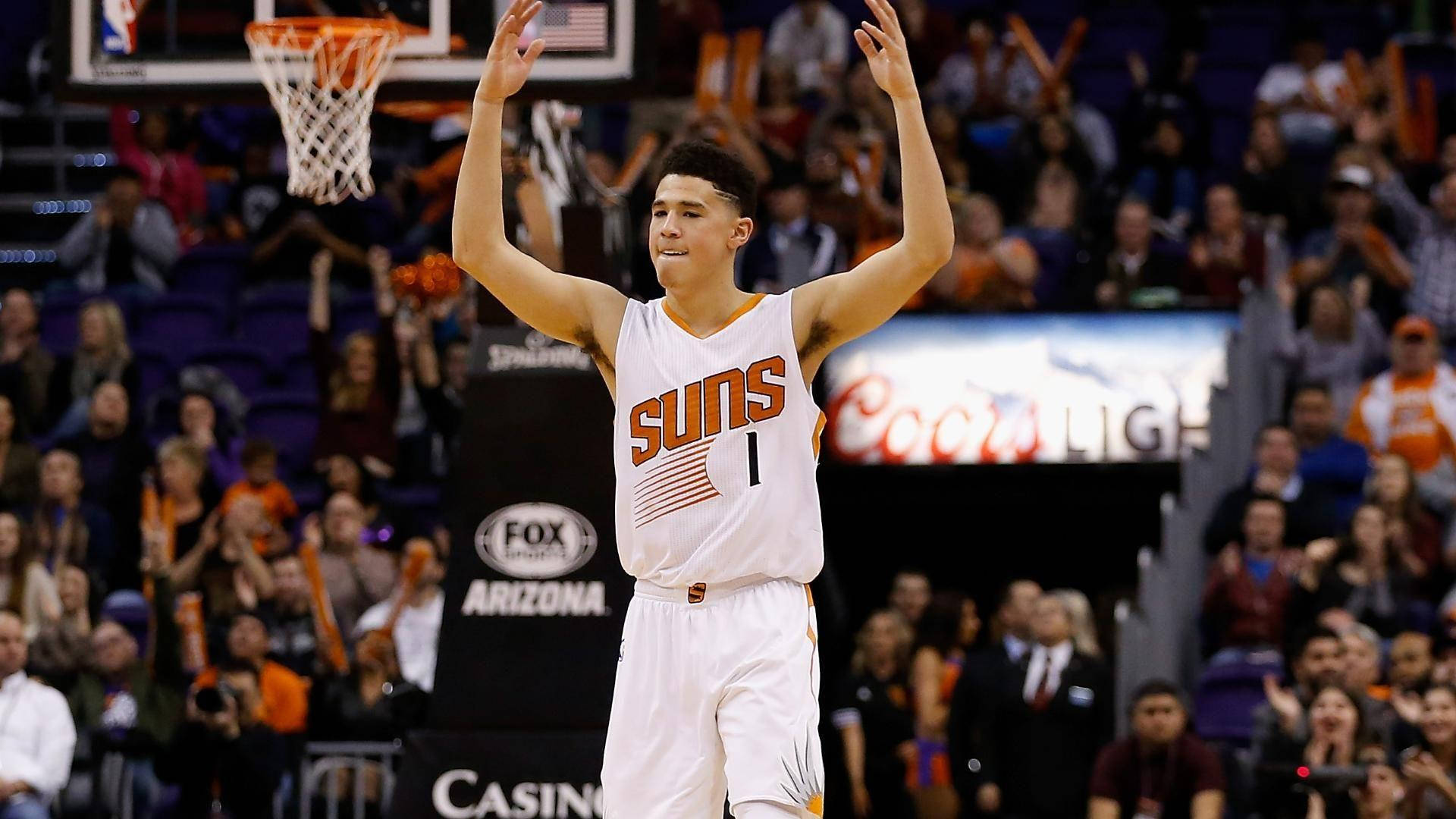 Download Devin Booker With Raised Hands Wallpaper