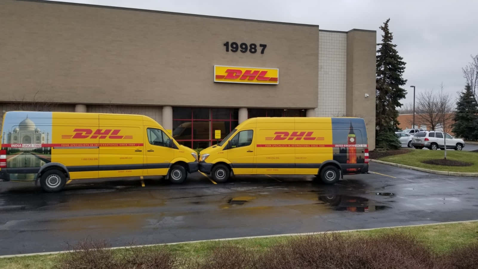 Dhl Vans Parked Outside Of A Building