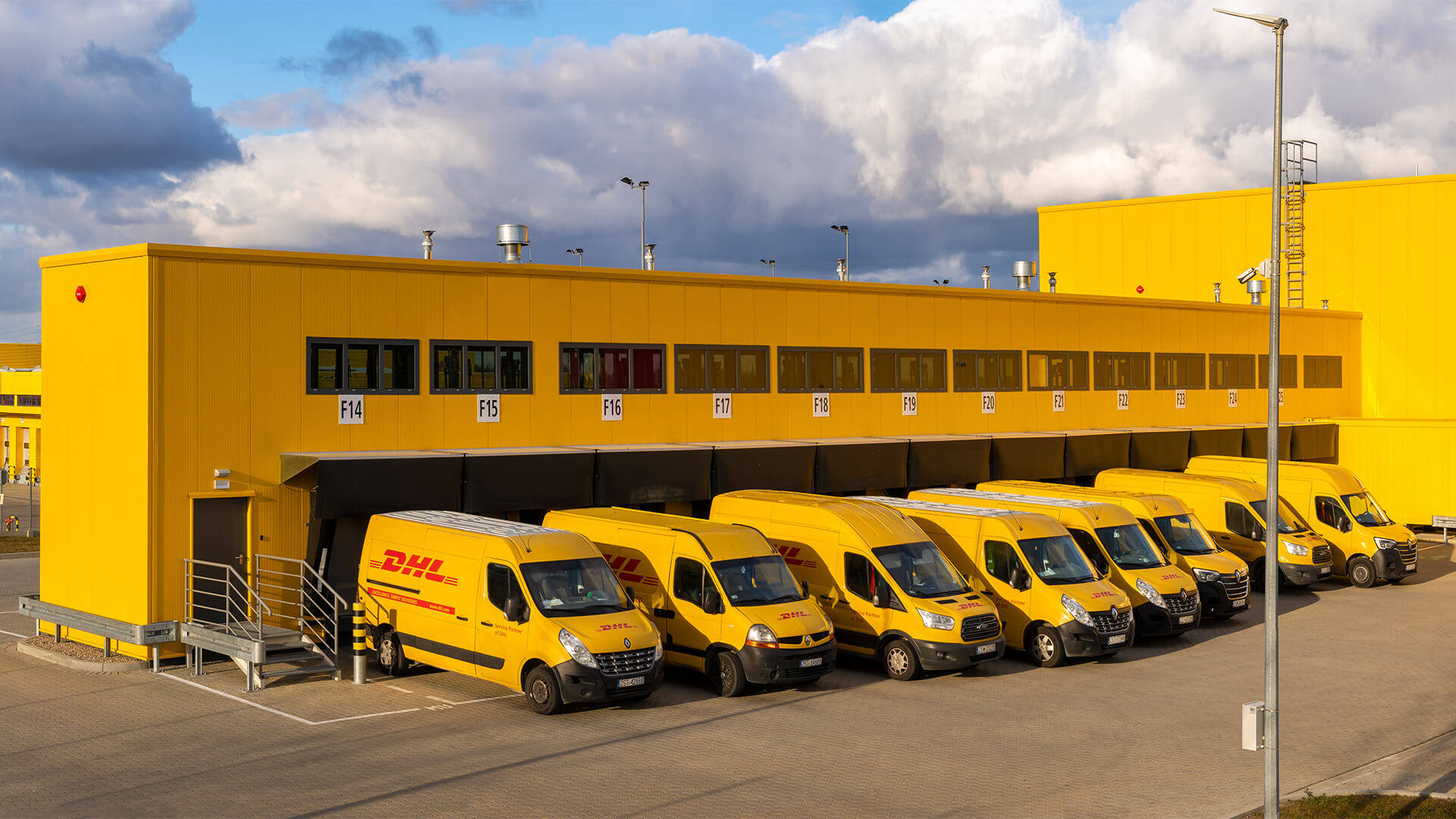 Caption: A DHL Delivery Van in a Parking Area Wallpaper