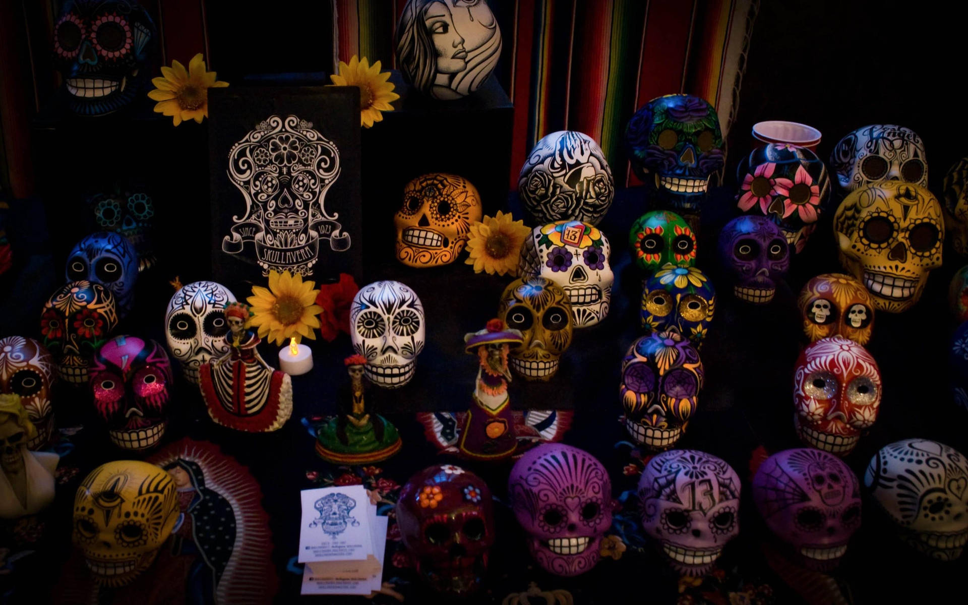 Celebrating Dia De Los Muertos: Vibrantly Adorned Laughing Skulls Wallpaper