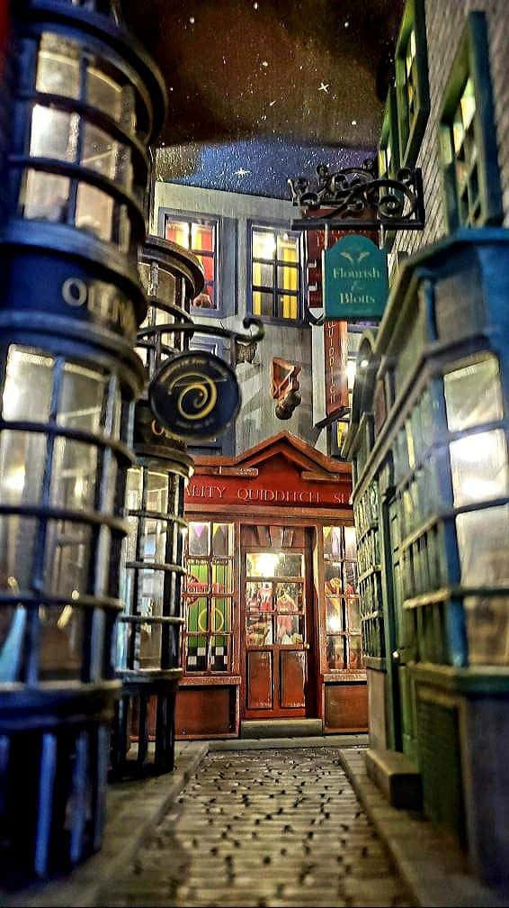 Magical Diagon Alley street bustling with life Wallpaper