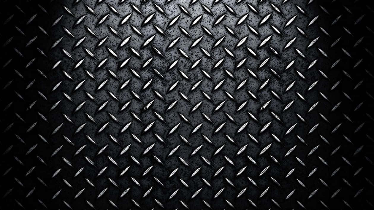 En sort metalplade med diamanter på den. Wallpaper