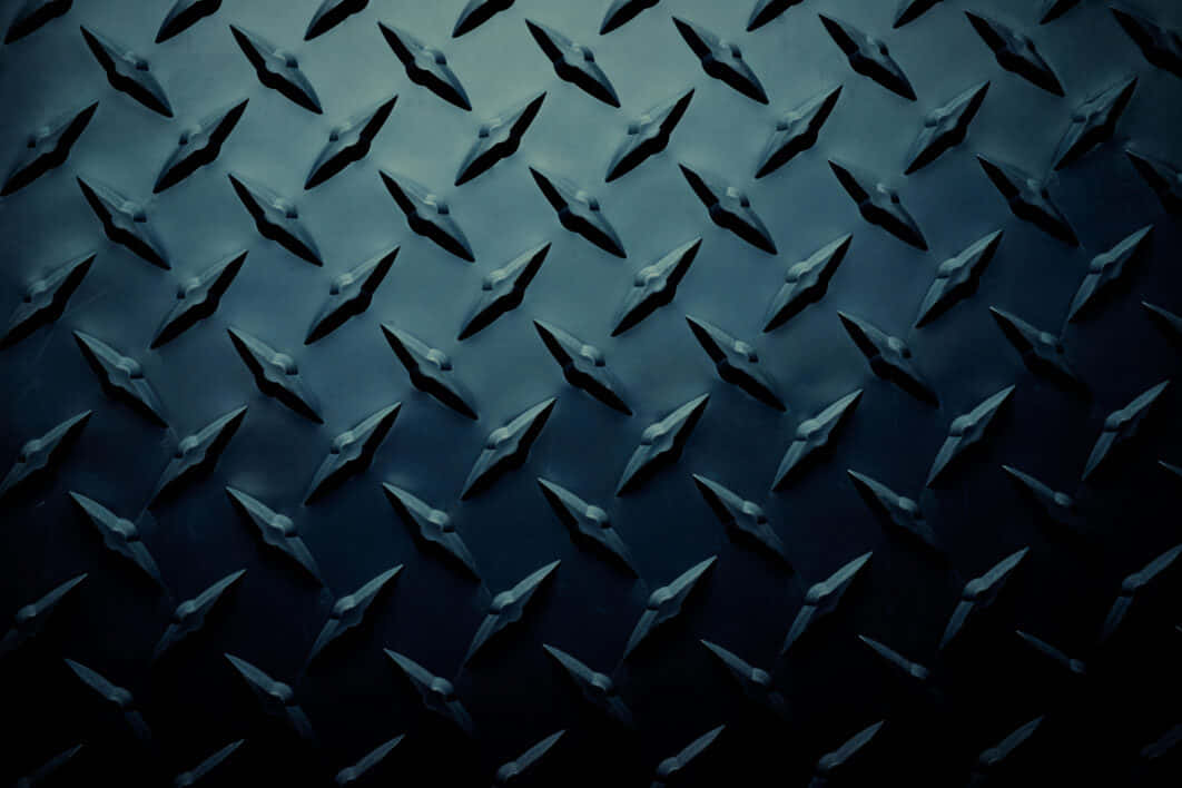 Ennärbild Av En Metallplatta Med Diamanter Wallpaper