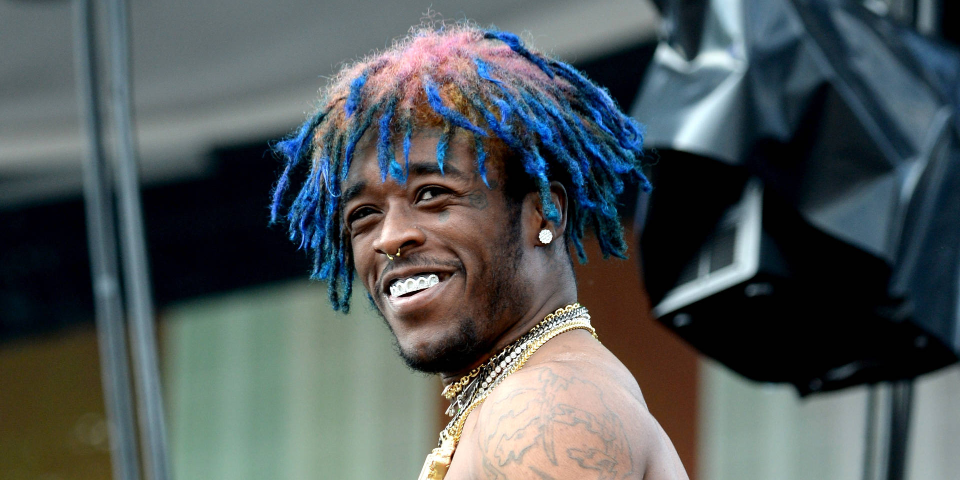 Lil Uzi Vert serving serious pearly whites. Wallpaper