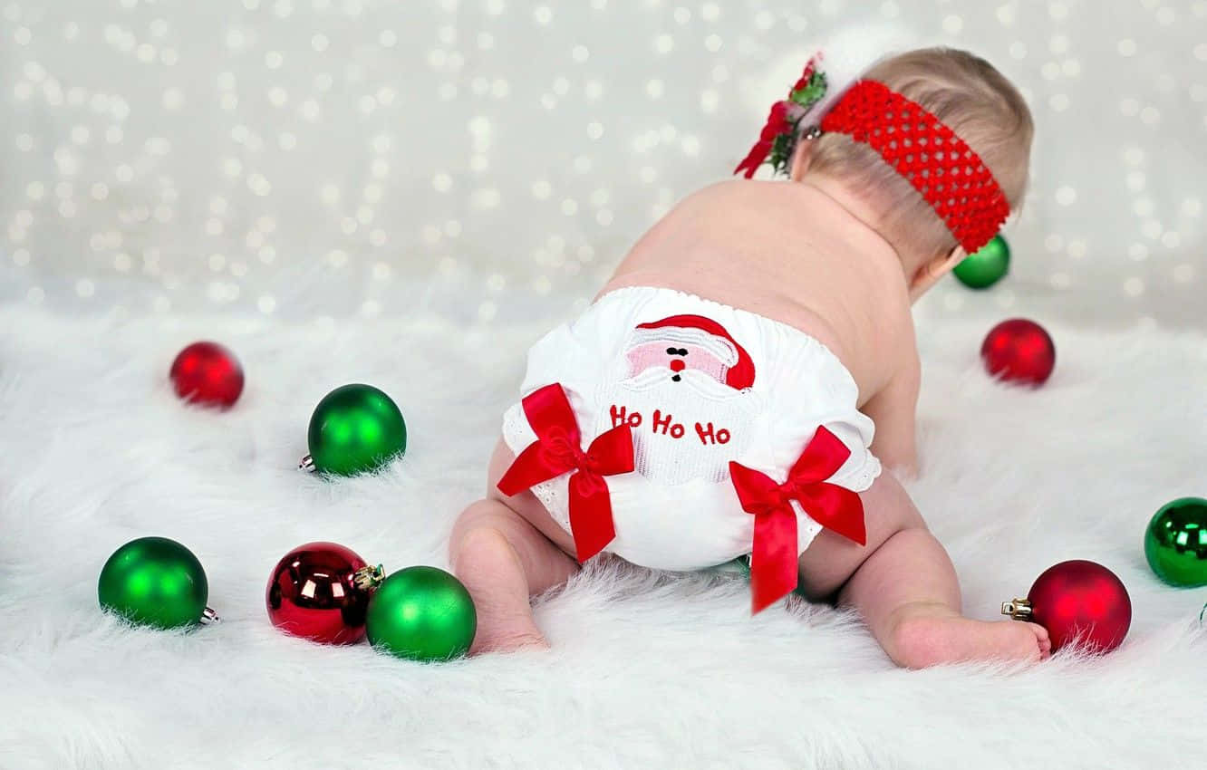 A Baby In A Diaper With Christmas Ornaments Around Him