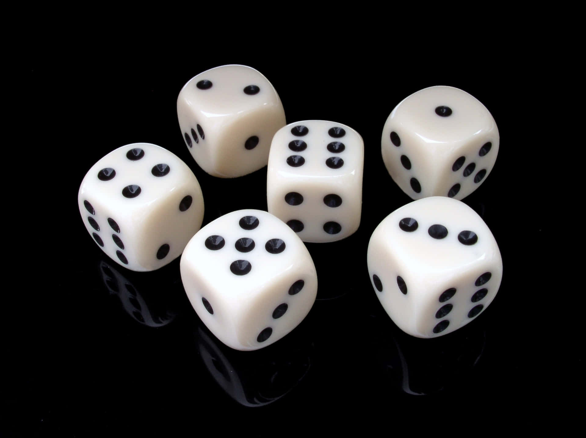 White Plastic Dice On A Black Surface