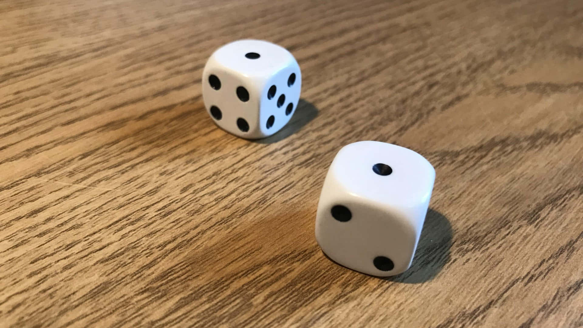 Two Dice On A Wooden Table