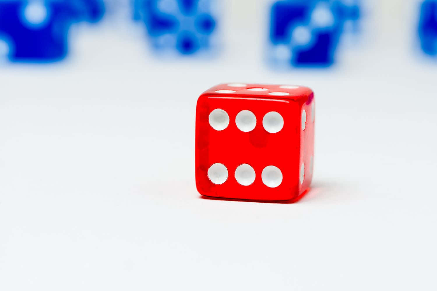 A Red And Blue Dice On A White Background