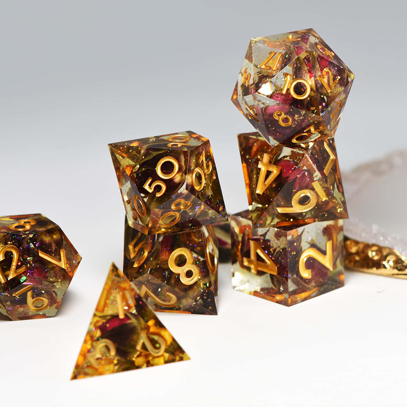 A Set Of Gold And Gold Dice With Numbers On Them