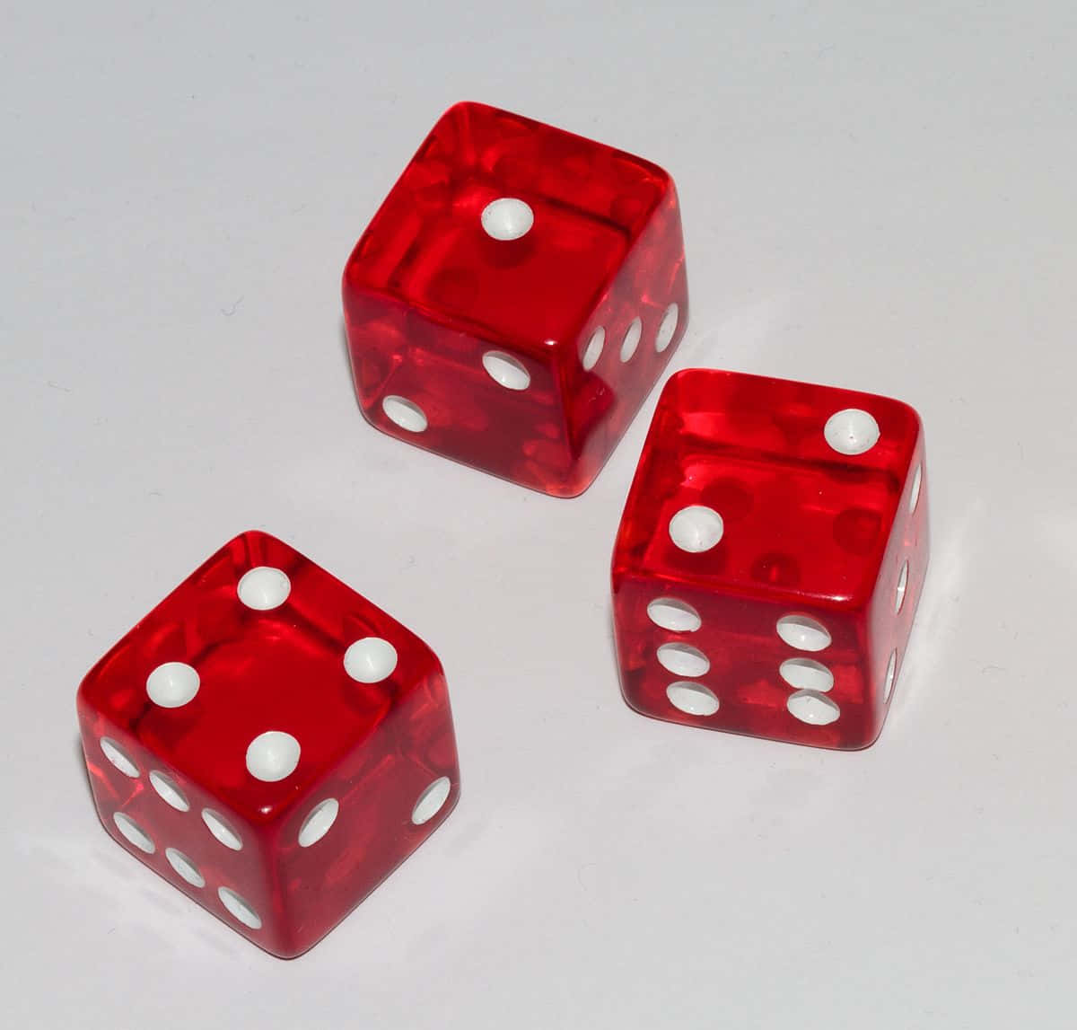 Three Red Dice With White Dots On Them