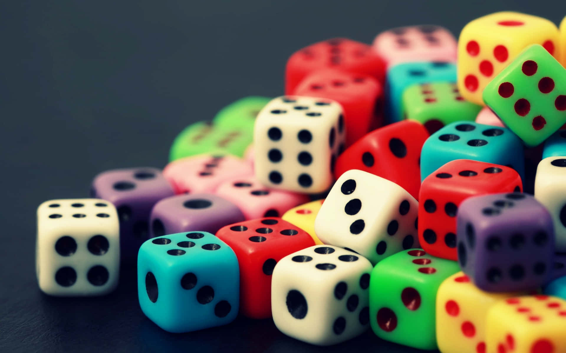 Colorful Dice On A Black Surface