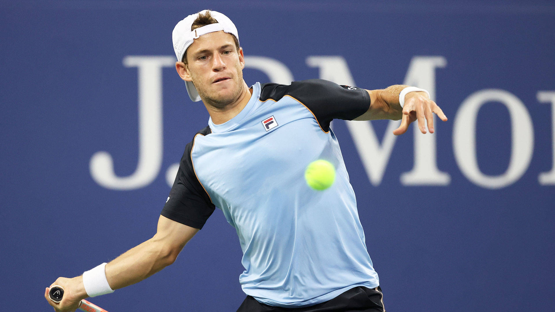 Professional tennis player Diego Schwartzman in action, skillfully approaching the ball. Wallpaper