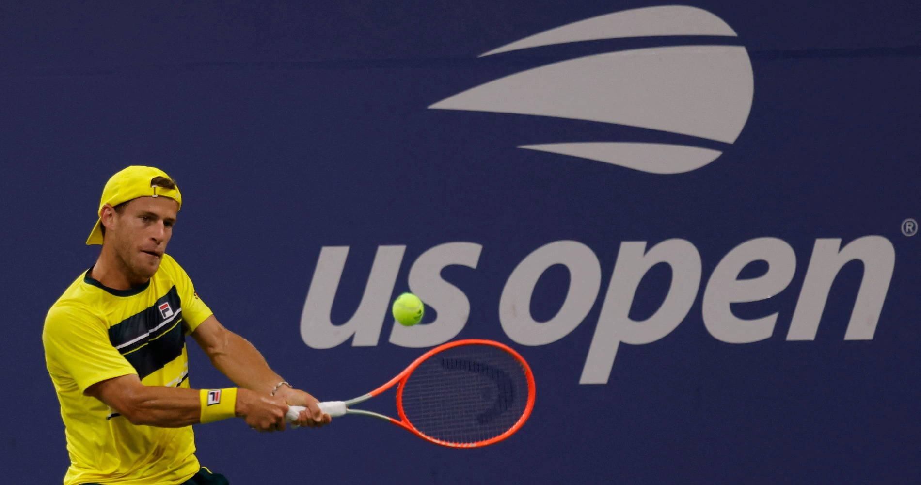Tennis Pro, Diego Schwartzman in action in yellow attire Wallpaper