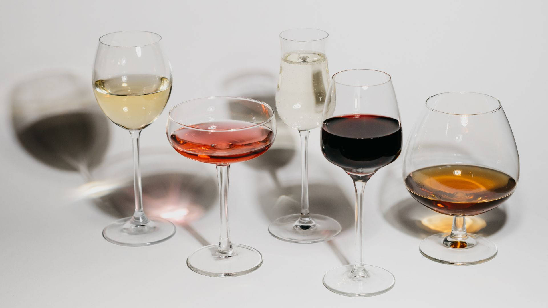 Different Colored Alcohol On Wine Glasses Wallpaper