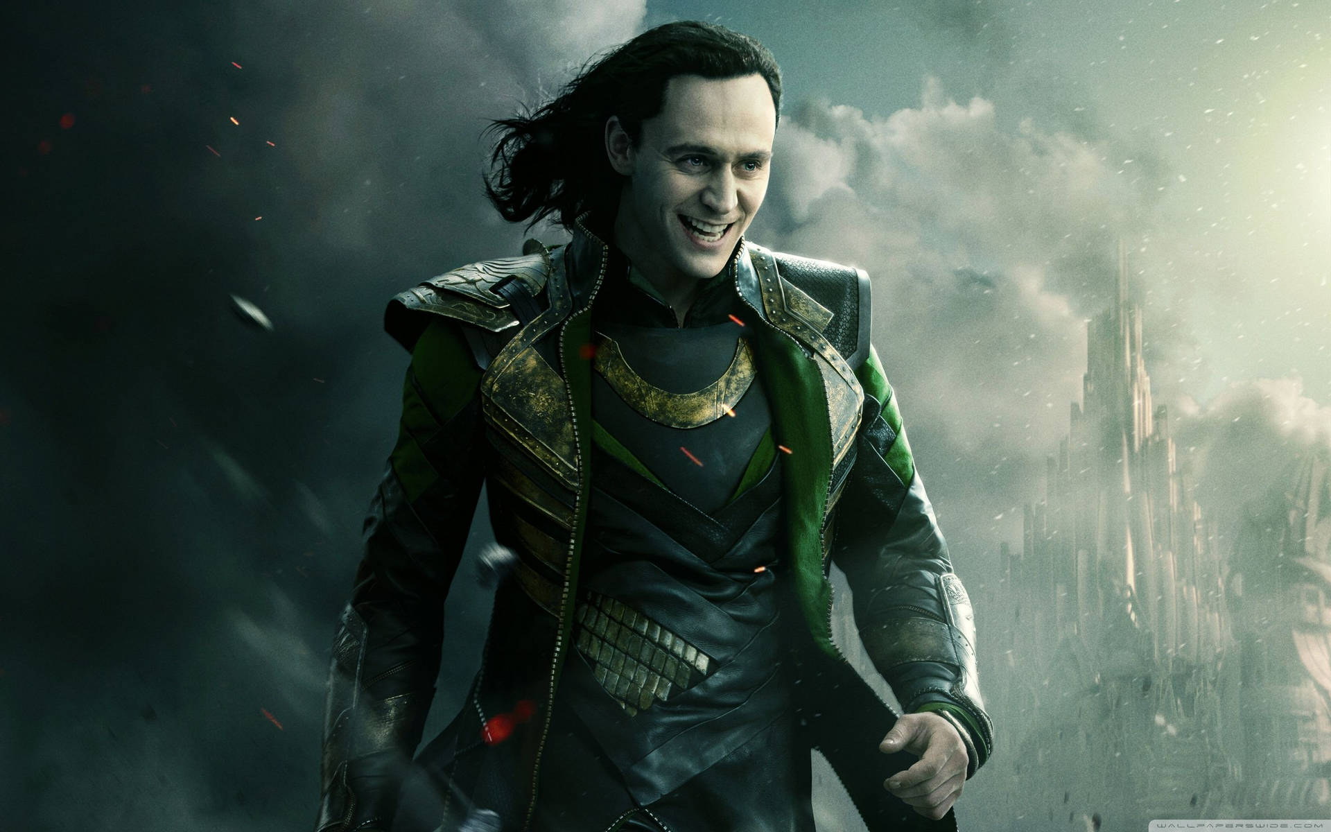 Loki stands in a backdrop of a battleground, his majestic cape billowing in the wind Wallpaper