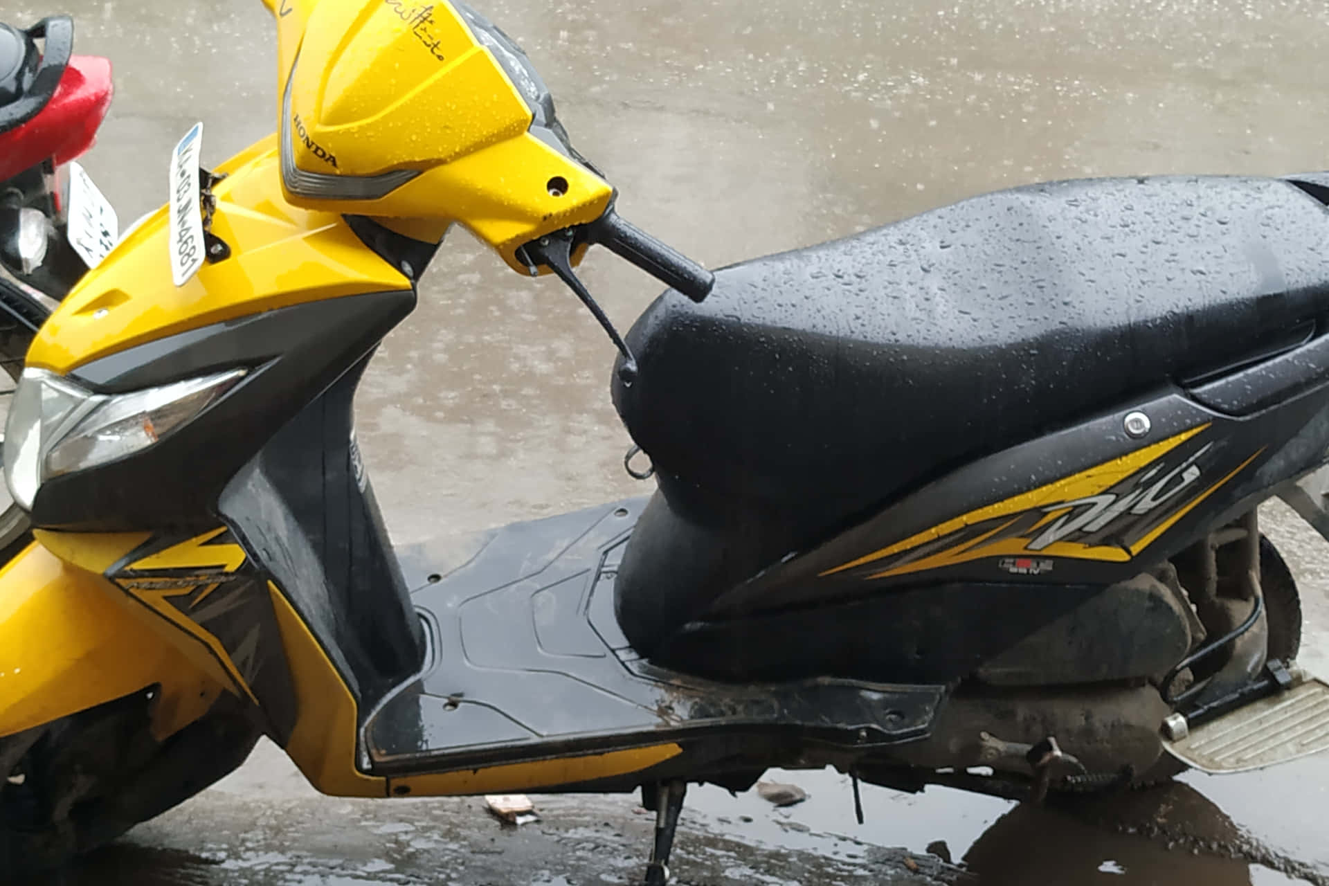 Dio Bike Drenched In Rain Water Wallpaper
