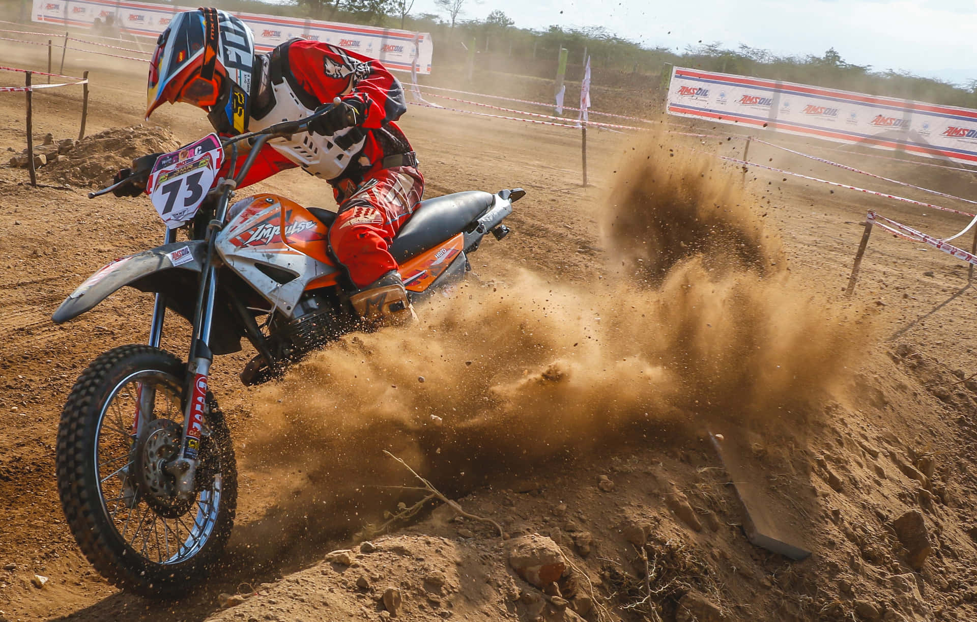 "Dirt Bike Rider Mid-jump on a Motocross Track"