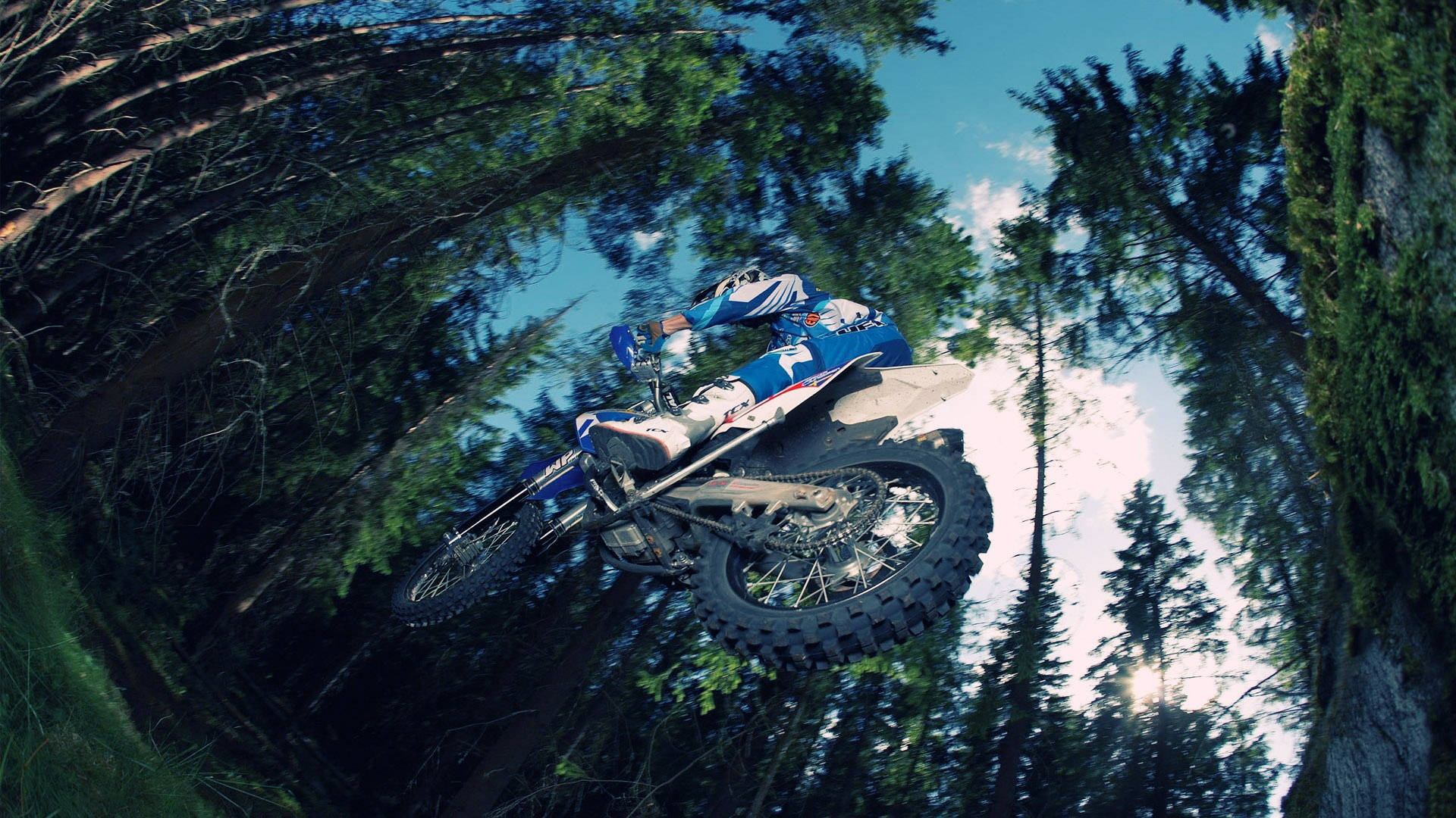 Thrilling Low Angle Shot of a High-Speed Dirt Bike Wallpaper
