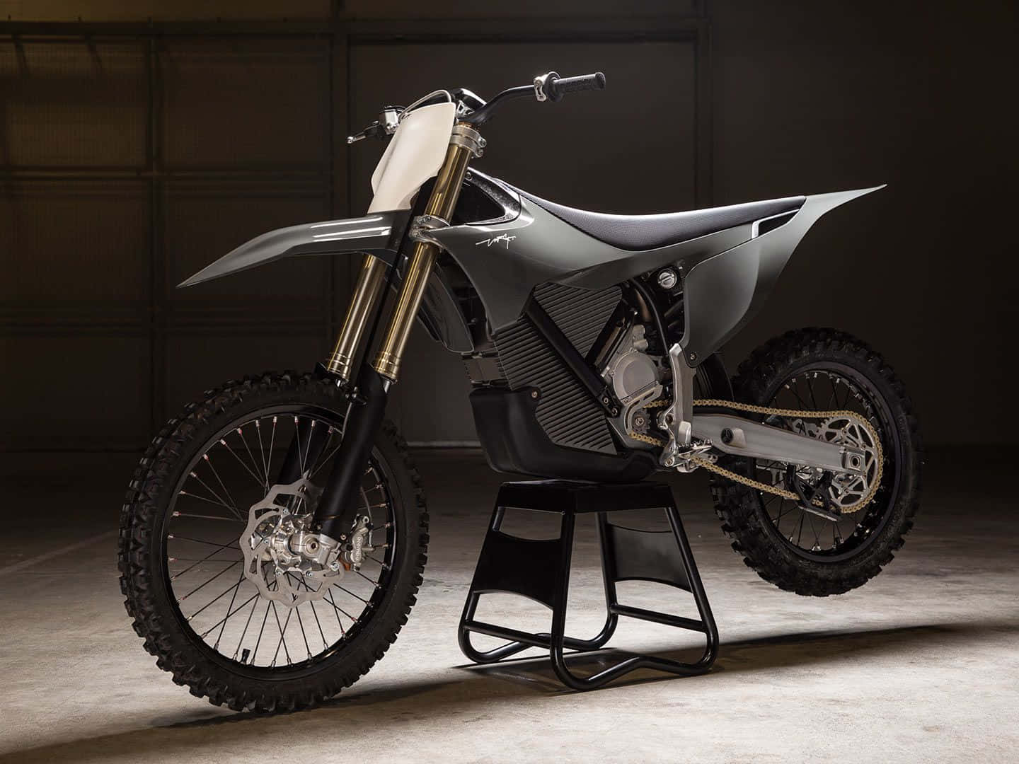 A Dirt Bike Is Sitting On A Stand In A Garage