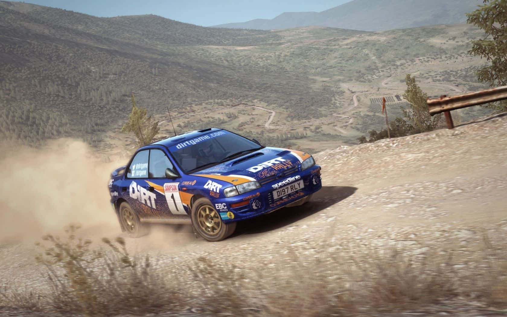 A Rally Car Driving On A Dirt Road Wallpaper
