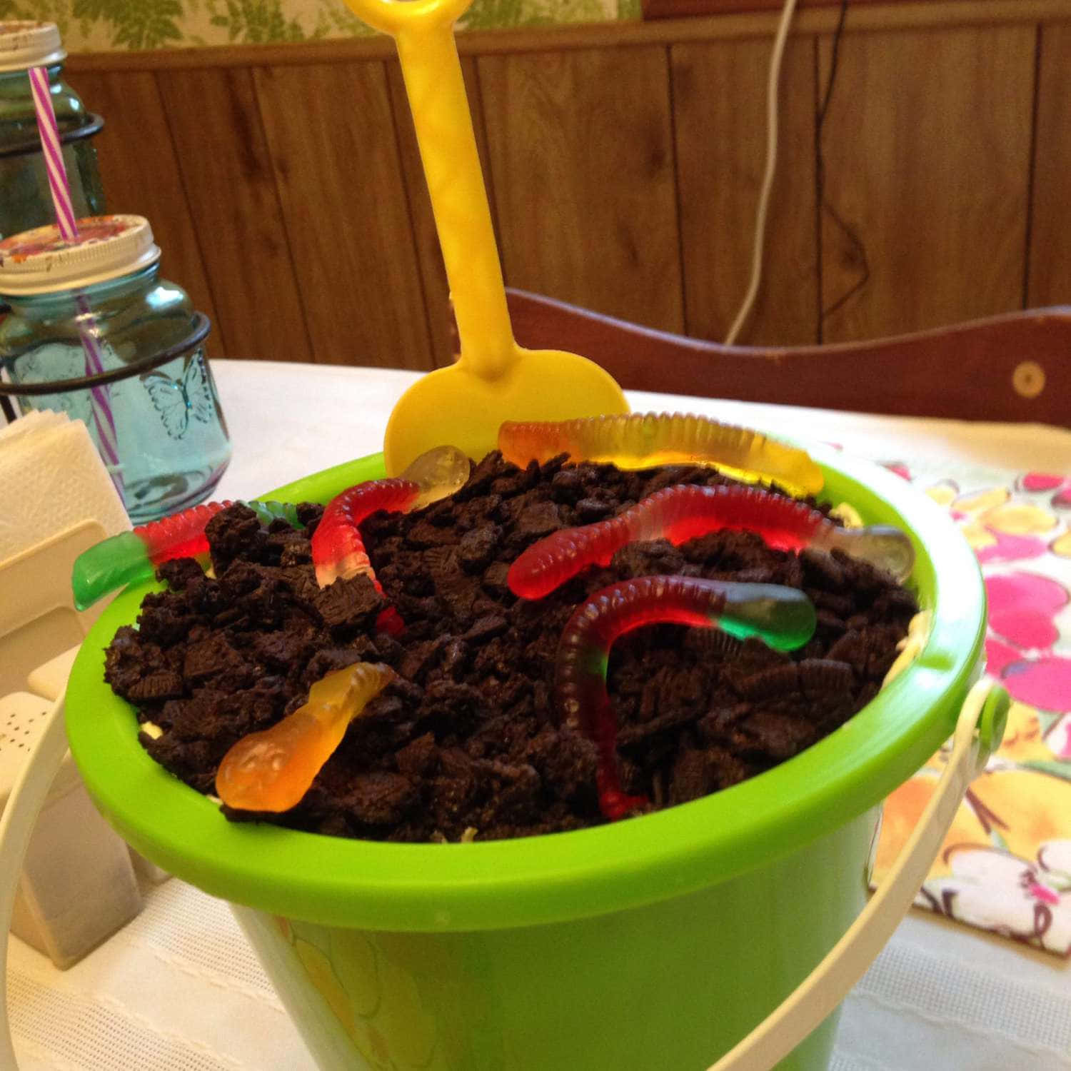 A Green Bucket With A Shovel