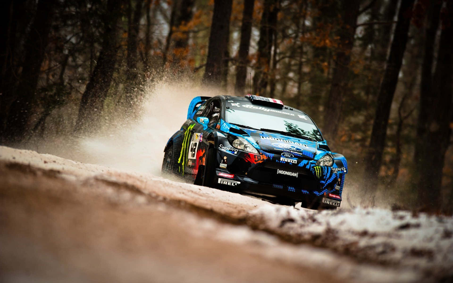 A Blue Rally Car Driving Through The Woods