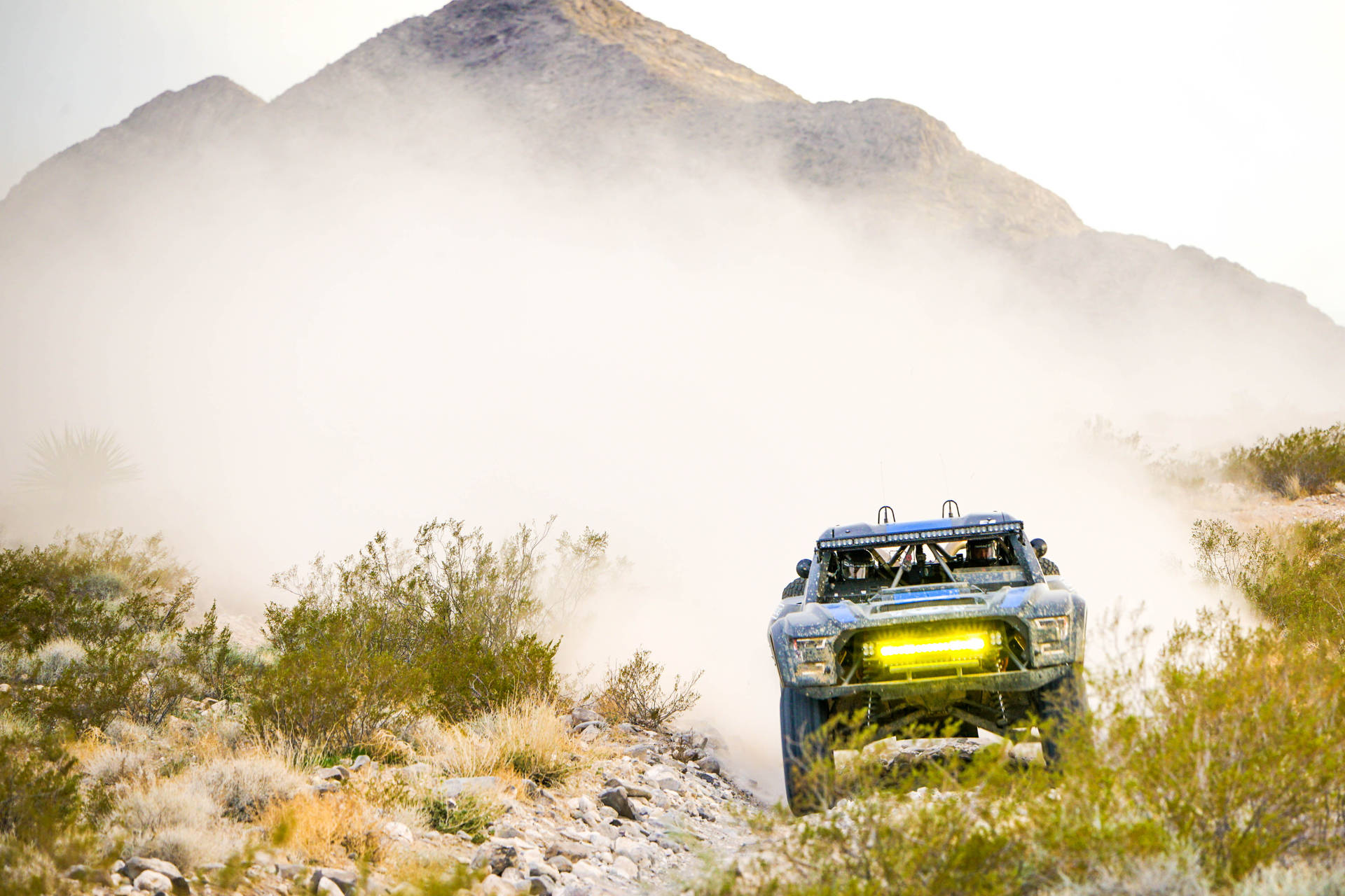 Dirt Rally Car With Yellow Headlamp Wallpaper