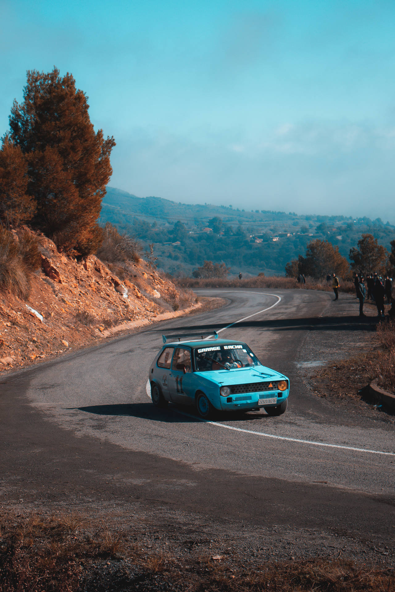 Light Blue Car Racing in Dirt Rally Games Wallpaper